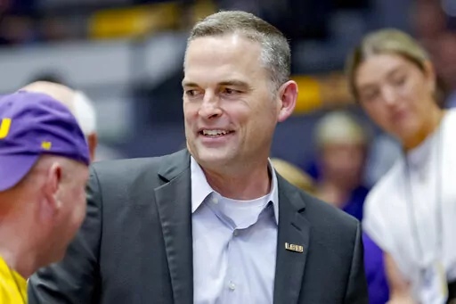 Former Murray State head coach Matt McMahon, center, talks with LSU fans after being hired as the head men's basketball coach for LSU during the second half of a women's college basketball game against Ohio State in the second round of the NCAA tournament, Monday, March 21, 2022, in Baton Rouge, La. Not long after Matt McMahon was hired to take over a Tigers program which remains under investigation because of NCAA allegations against former coach Will Wade, virtually every player on the roster 