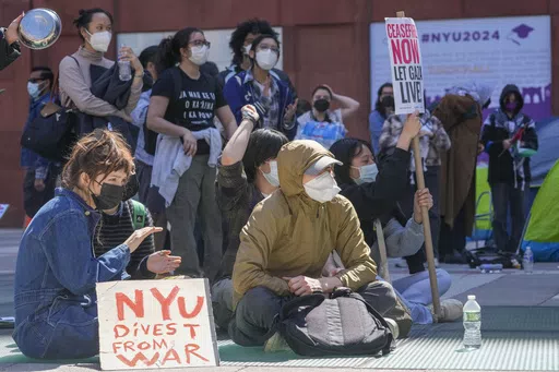 New York University students and pro-Palestinian supporters rally outside the NYU Stern School of Business building, Monday, April 22, 2024, in New York. Some NYU students facing discipline for their actions during this spring's pro-Palestinian protests have been assigned a 49-page workbook that includes a "Simpsons"-based module on ethical decision making. Some have been asked to write an apologetic "reflection paper" and submit it "in 12-point Times New Roman or similar font."(AP Photo/Mary Al