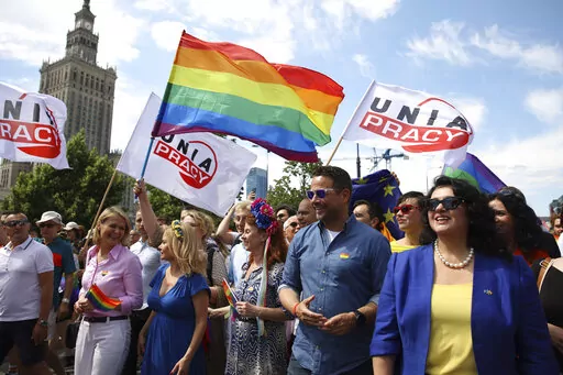 Warsaw's mayor Rafal Trzaskowski, second right, and European Commissioner for Equality, Hanna Dalli, right,  take part in the 'Warsaw and Kyiv Pride' marching for freedom in Warsaw, Poland, Saturday, June 25, 2022. Due to Russia's full-scale war against Ukraine the 10th anniversary of the equality march in Kyiv can't take place in the usual format in the Ukrainian capital. The event joined Warsaw's yearly equality parade, the largest gay pride event in central Europe, using it as a platform to k
