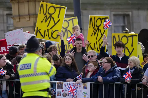 Protestors wait for the arrival of King Charles III and Camilla, the Queen Consort to visit Liverpool Central Library, and to officially mark the Library's twinning with Ukraine's first public Library, the Regional Scientific Library in Odesa, in Liverpool, England, Wednesday, April 26, 2023. There will be dissenters among the cheering crowds when King Charles III travels by gilded coach to his coronation. More than 1,500 protesters will be dressed in yellow for maximum visibility and they plan 