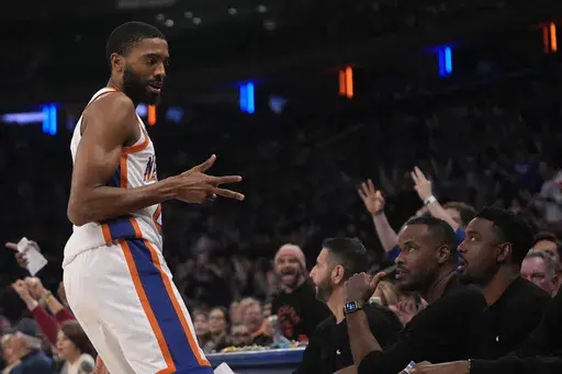 New York Knicks' Mikal Bridges gestures towards the New Orleans Pelicans bench after scoring a 3-point basket during the first half of an NBA basketball game, Sunday, Dec. 1, 2024, in New York. (AP Photo/Pamela Smith)