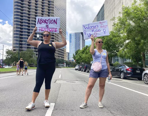 Protesters wave signs and demonstrate in support of abortion access in front of a New Orleans courthouse on July 8, 2022. Louisiana authorities have once again been blocked from enforcing the state’s near total ban on abortion. A state judge in Baton Rouge released an order Tuesday, July 12, 2022, blocking enforcement while lawyers for a north Louisiana clinic and other supporters of abortion rights pursue a lawsuit. (AP Photo/Rebecca Santana, File)