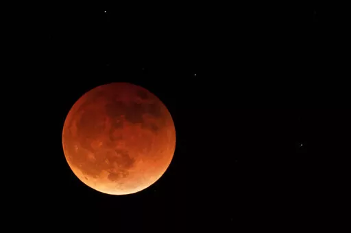 The moon is shown during a full lunar eclipse, Sunday, May 15, 2022, near Moscow, Idaho, with the reddish color caused by it passing into the shadow of the Earth. A Tuesday, Nov. 8, 2022 total lunar eclipse will be visible throughout North America in the predawn hours _ the farther west, the better _ and across Asia, Australia and the rest of the Pacific after sunset. (AP Photo/Ted S. Warren, File)