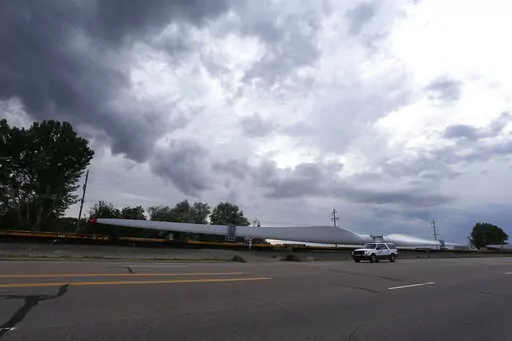 In this June 30, 2016, file photo, a train carries blades for wind turbines bound for another state through Rocky Ford, Colo., in Otero County. Both Rocky Ford, Colo., and Dawson, Ga., were classified as urban areas after the 2010 census because they had populations over 2,500 residents. Under new criteria posted this spring by the U.S. Census Bureau, these communities would no longer be designated as urban. The new criteria require places to have 2,000 housing units, which is equivalent to 5,00
