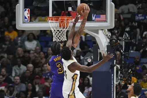 Los Angeles Lakers forward Anthony Davis (3) and New Orleans Pelicans center Yves Missi battle under the basket in the first half of an NBA basketball game in New Orleans, Saturday, Nov. 16, 2024. (AP Photo/Gerald Herbert)
