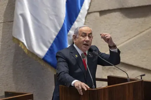 Israel's Prime Minister Benjamin Netanyahu addresses lawmakers in the Knesset, Israel's parliament, in Jerusalem. Monday Nov. 18, 2024. (AP Photo/Ohad Zwigenberg, File)