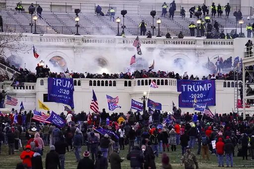 Violent protesters, loyal to President Donald Trump, storm the Capitol, Wednesday, Jan. 6, 2021, in Washington. The House committee investigating the Jan. 6 insurrection poked another hole in the pro-Trump conspiracy theory that federal agents orchestrated the attack, confirming on Tuesday, Jan. 11, 2022, that a man at the center of the claims said he’d never been an FBI informant. (AP Photo/John Minchillo, File)
