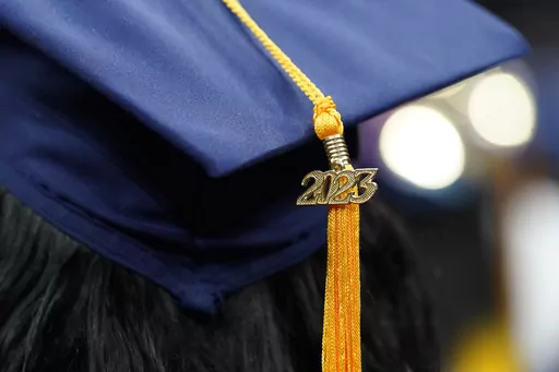 A tassel with 2023 on it rests on a graduation cap as students walk in a procession for Howard University's commencement in Washington, Saturday, May 13, 2023. A federal appeals court says a Biden administration plan to provide student debt relief for people who say they were victims of misleading information by trade schools or colleges is “almost certainly unlawful.” The 5th U.S. Circuit Court of Appeals ruling, dated Thursday, April 4, 2024, came in a court challenge filed by Career Colle