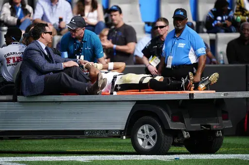 New Orleans Saints wide receiver Chris Olave is taken off the field after getting hurt during the first half of an NFL football game against the Carolina Panthers Sunday, Nov. 3, 2024, in Charlotte, N.C. (AP Photo/Jacob Kupferman)