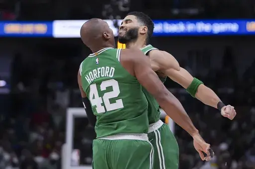 Boston Celtics forward Jayson Tatum celebrates with center Al Horford (42) after his go-ahead, game-winning shot in the final second of the second half of an NBA basketball game in New Orleans, Friday, Jan. 31, 2025. (AP Photo/Gerald Herbert)