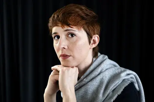 Voice actor Sarah Elmaleh poses for a photo in Los Angeles on Thursday, Feb. 1, 2024. While negotiators with the Screen Actors Guild-American Federation of Television and Radio Artists have made gains in bargaining over wages and job safety in their video game contract, or interactive media agreement, leaders say talks have stalled over a key issue: protections over the use of artificial intelligence. (AP Photo/Richard Vogel)