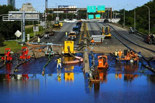 Workers pump water from a flooded section of Interstate 676 in Philadelphia on Sept. 3, 2021 in the aftermath of downpours and high winds from the remnants of Hurricane Ida that hit the area. Meteorologists are retiring the name Ida from the list of Atlantic hurricane names. Last year's Ida was the fifth costliest U.S. storm on record, causing $75 billion in damage and killing 55 people. (AP Photo/Matt Rourke, File)