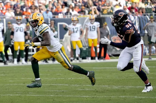 Green Bay Packers running back Aaron Jones heads for the end zone for a touchdown as Chicago Bears linebacker T.J. Edwards pursues during the second half of an NFL football game Sunday, Sept. 10, 2023, in Chicago. (AP Photo/Nam Y. Huh)