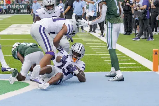 Kansas State safety VJ Payne (19) comes down with an interception against Tulane wide receiver Yulkeith Brown (5) next to Kansas State safety Marques Sigle (21) during the fourth quarter of an NCAA college football game in New Orleans, Saturday, Sept. 7, 2024. (AP Photo/Matthew Hinton)