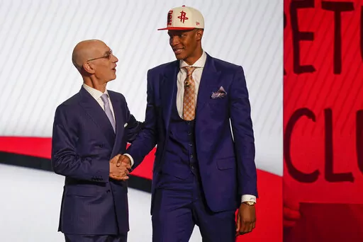 Jabari Smith Jr., right, is congratulated by NBA Commissioner Adam Silver after being selected third overall in the NBA basketball draft by the Houston Rockets, Thursday, June 23, 2022, in New York. (AP Photo/John Minchillo)