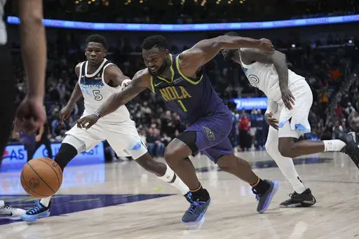 New Orleans Pelicans forward Zion Williamson (1) drives to the basket ahead of Minnesota Timberwolves guard Anthony Edwards (5) and forward Julius Randle (30) in the second half of an NBA basketball game in New Orleans, Tuesday, Jan. 7, 2025. The Timberwolves won 104-97 (AP Photo/Gerald Herbert)