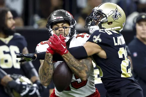 New Orleans Saints cornerback Marshon Lattimore breaks up a pass intended for Tampa Bay Buccaneers wide receiver Mike Evans during the first half of an NFL football game in New Orleans, Sunday, Sept. 18, 2022. (AP Photo/Butch Dill)