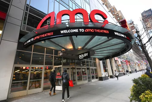 People walk by the AMC 34th Street theater on March 5, 2021, in New York. AMC Theaters, the nation's largest movie theater chain, on Monday unveiled a new pricing scheme in which seat location determines how much your movie ticket costs. Seats in the middle will cost a dollar or two more, while seats in the front row will be slightly cheaper. (Photo by Evan Agostini/Invision/AP, File)
