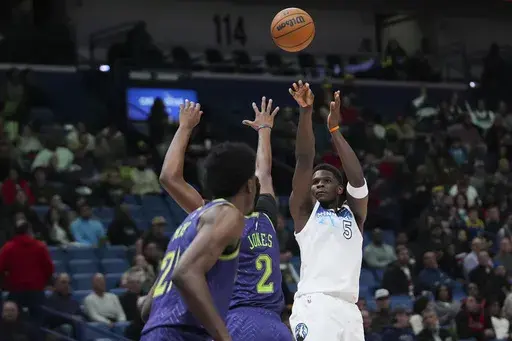 Minnesota Timberwolves guard Anthony Edwards (5) shoots against New Orleans Pelicans forward Herbert Jones (2) in the first half of an NBA basketball game in New Orleans, Tuesday, Jan. 7, 2025. (AP Photo/Gerald Herbert)