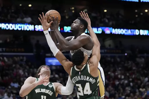 New Orleans Pelicans forward Zion Williamson goes to the basket over Milwaukee Bucks forward Giannis Antetokounmpo (34) in the first half of an NBA basketball game in New Orleans, Thursday, March 28, 2024. (AP Photo/Gerald Herbert)