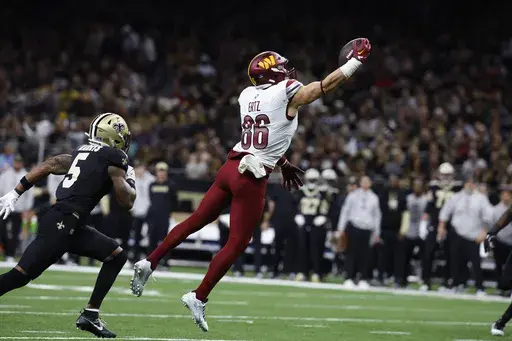 Washington Commanders tight end Zach Ertz (86) makes a catch in the first half of an NFL football game against the New Orleans Saints in New Orleans, Sunday, Dec. 15, 2024. (AP Photo/Butch Dill)