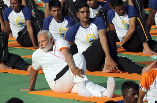 FILE-Indian Prime Minister Narendra Modi performs yoga to mark International Day of Yoga in Dehradun, India, Thursday, June 21, 2018. India's Prime Minister Narendra Modi, known for his reputation of an ascetic, is participating in a yoga session at the U.N. during his three-day visit to the United States. Wednesday's event is aimed to raise awareness worldwide of the benefits of practicing yoga, some nine years after the Hindu nationalist leader successfully lobbied the U.N. to designate June 2