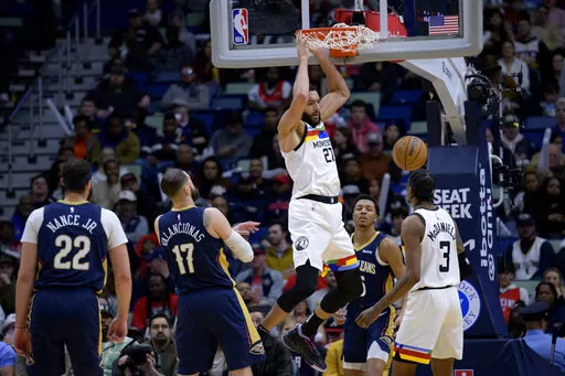Minnesota Timberwolves center Rudy Gobert (27) dunks against New Orleans Pelicans guard Trey Murphy III, rear, during the first half of an NBA basketball game in New Orleans, Wednesday, Jan. 25, 2023. (AP Photo/Matthew Hinton)