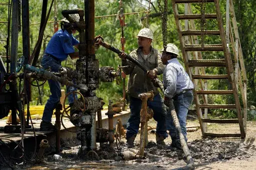 Oil well workers prepare to plug an orphaned well on the Rooke family ranch, May 18, 2021, near Refugio, Texas. An environmental group sued the Department of Interior in federal court Thursday, July 11, 2024, for allegedly failing to account for the harms caused by delays in properly shutting down offshore oil and gas infrastructure. (AP Photo/Eric Gay, File)