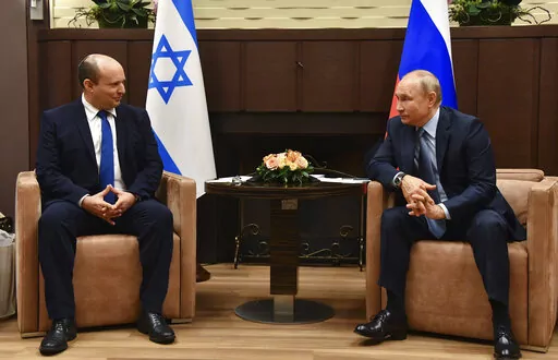 Russian President Vladimir Putin, right, and Israeli Prime Minister Naftali Bennett speak during their meeting in Sochi, Russia, Oct. 22, 2021. Just a year ago, Naftali Bennett was struggling for his political survival as Israel headed toward its fourth consecutive election. Today, the Israeli prime minister is at the forefront of global efforts to end the war in Ukraine. (Evgeny Biyatov, Sputnik, Kremlin Pool Photo via AP, File)