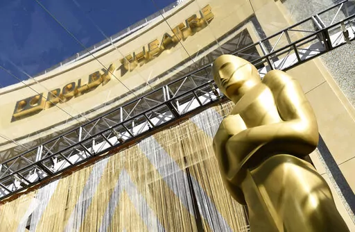 An Oscar statue is pictured underneath the entrance to the Dolby Theatre on Feb. 24, 2016, in Los Angeles. The Oscars will be held on Sunday, March 27 at the Dolby Theatre in Los Angeles. The ceremony is set to begin at 8 p.m. ET and will be broadcast live on ABC. (Photo by Chris Pizzello/Invision/AP, File)