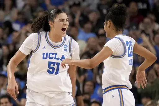 UCLA center Lauren Betts (51) celebrates with forward Kendall Dudley (22) during the second half of a game against Richmond in the second round of the NCAA college basketball tournament Sunday, March 23, 2025, in Los Angeles. (AP Photo/Eric Thayer)