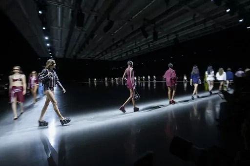 Models wear creations as part of the Gucci women's Spring Summer 2024 collection presented in Milan, Italy, Friday, Sept. 22, 2023. (AP Photo/Luca Bruno)