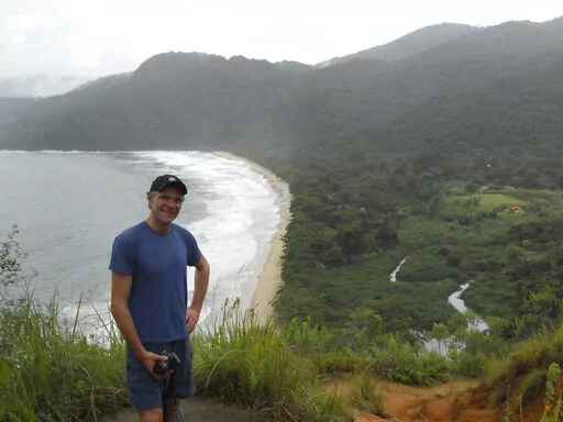 In this photo provided by Tom Hennigan, British Journalist Dom Phillips poses for a photo during a hike in Paraty, Brazil, April 2, 2010. British journalist Dom Phillips’ quest to unlock the secrets of how to preserve Brazil’s Amazon was cut short this June 2022, when he was killed along with a colleague in the heart of the forest he so cherished. (Tom Hennigan via AP)