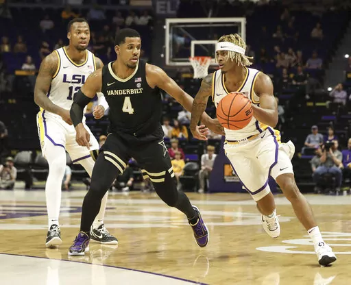 LSU guard Adam Miller (44) drives against Vanderbilt guard Jordan Wright (4) during the first half of an NCAA college basketball game Wednesday, Feb. 22, 2023, in Baton Rouge, La. (Morgan Werther/The Advocate via AP)