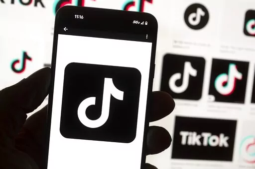 The TikTok logo is seen on a cell phone on Oct. 14, 2022, in Boston. Kansas Gov. Laura Kelly on Wednesday, Dec. 28, 2022, banned the use of TikTok on the state-issued devices of government workers under her control, becoming one of the first Democratic governors to restrict the popular social media app. (AP Photo/Michael Dwyer, File)