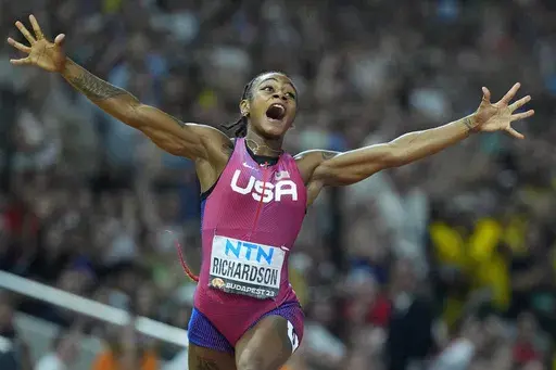 Sha'Carri Richardson, of the United States, celebrates after winning the gold medal in the final of the Women's 100-meters during the World Athletics Championships in Budapest, Hungary, Aug. 21, 2023. (AP Photo/Petr David Josek, File)