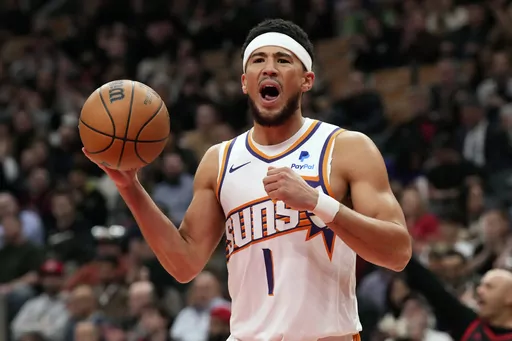 Phoenix Suns' Devin Booker reacts during an NBA basketball game against the Toronto Raptors in Toronto on Wednesday, Nov. 29, 2023. (Chris Young/The Canadian Press via AP)