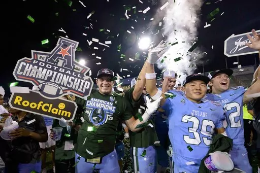 Tulane tight end Will Wallace, left, celebrates his team's victory against Central Florida at the end of the American Athletic Conference championship NCAA college football game in New Orleans, Saturday, Dec. 3, 2022. The American Athletic Conference released its 2023 football schedule on Tuesday that includes the league's six incoming teams. Charlotte, Florida Atlantic, North Texas, Rice, UAB and UTSA all officially join the AAC on July 1. (AP Photo/Matthew Hinton, File)