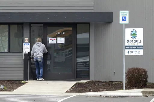 A woman enters the Great Circle drug treatment center in Salem, Ore., on March 8, 2022. Two years ago, Oregonians voted to decriminalize drugs and dedicate hundreds of millions of dollars to treatment services, but the state's first-in-the-nation drug decriminalization has had a rocky start. Secretary of State Shemia Fagan said on Thursday, Jan. 19, 2023, as she released an audit of the program that it's too early to call it a failure. (AP Photo/Andrew Selsky, File)