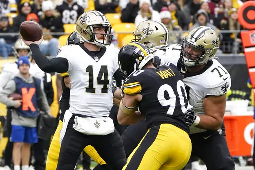 New Orleans Saints quarterback Andy Dalton (14) gets off a pass under pressure by Pittsburgh Steelers linebacker T.J. Watt (90) with offensive tackle Ryan Ramczyk (71) blocking during the first half of an NFL football game in Pittsburgh, Sunday, Nov. 13, 2022. (AP Photo/Keith Srakocic)