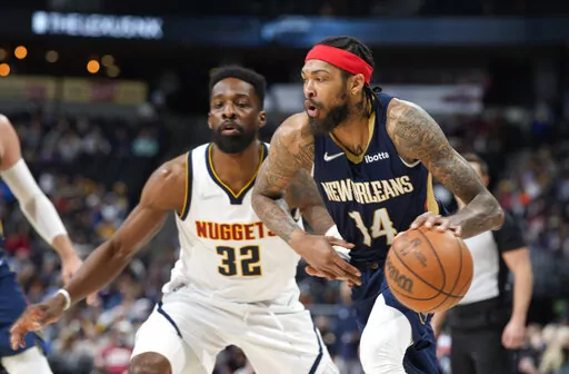 New Orleans Pelicans forward Brandon Ingram,  right, drives past Denver Nuggets forward Jeff Green in the second half of an NBA basketball game Sunday, March 6, 2022, in Denver. (AP Photo/David Zalubowski)
