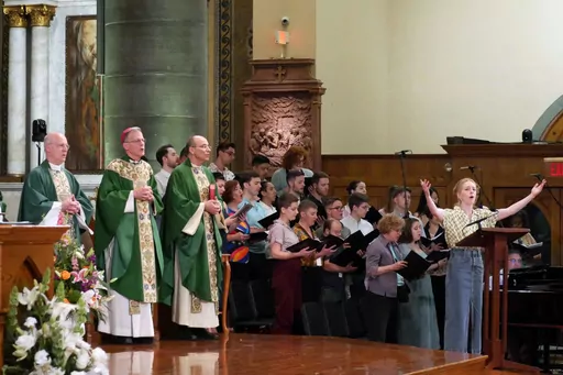 In this photo provided by America Media, from left, the Rev. James Martin, Archbishop John Wester of Santa Fe, N.M., and Rev. Eric Andrews attend the closing Mass for the Outreach conference at the Church of St. Paul the Apostle, in New York, June 18, 2023. Martin is the founder of Outreach, a unique Jesuit-run program of outreach to LGBTQ+ Catholics. (Cristobal Spielmann/America Media via AP)