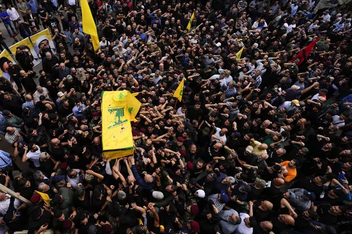 Hezbollah fighters carry the coffin of their comrade, Mohammed Ali Assaf, who was killed by an Israeli strike in Syria Friday morning, during his funeral procession in the southern Beirut suburb of Dahiyeh, Lebanon, Saturday, Nov. 11, 2023. Lebanon's militant Hezbollah group has announced the death of seven of its fighters without giving details on where they were killed. A Hezbollah official and a Lebanese security official said the seven fighters were killed in neighboring Syria Friday morning