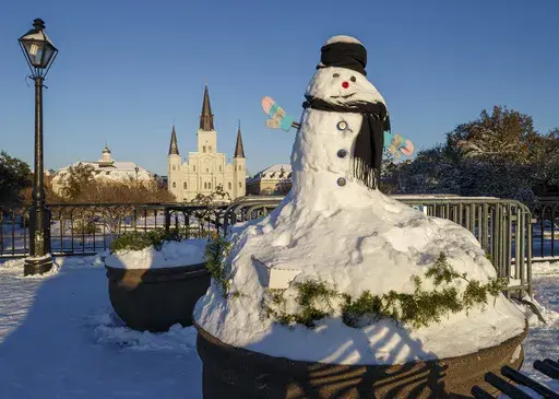 A snowman was made in front of Jackson Square and the St. Louis Cathedral in New Orleans, La. during the snowstorm on Tuesday, photographed early Wednesday morning, Jan. 22, 2025. (David Grunfeld/The New Orleans Advocate via AP)