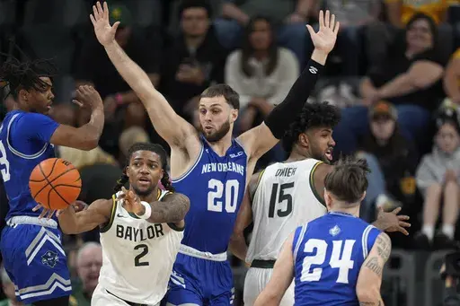 Baylor guard Jayden Nunn (2) passes the ball out as New Orleans' Luke Davis (20) and Kohen Rowbatham (24) defend in the second half of an NCAA college basketball game Wednesday, Nov. 27, 2024, in Waco, Texas. (AP Photo/Tony Gutierrez)