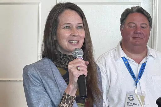Jen Easterly, Director of Department of Homeland Security's Cybersecurity and Infrastructure Security Agency, speaks during the summer conference of the National Association of Secretaries of State on July 7, 2022, in Baton Rouge, La., as Kyle Ardoin, Louisiana Secretary of State listens. Election officials have a long list of challenges as they prepare for the upcoming midterms. They face a myriad of threats, both foreign and domestic, as they work to protect voting systems and run a smooth ele