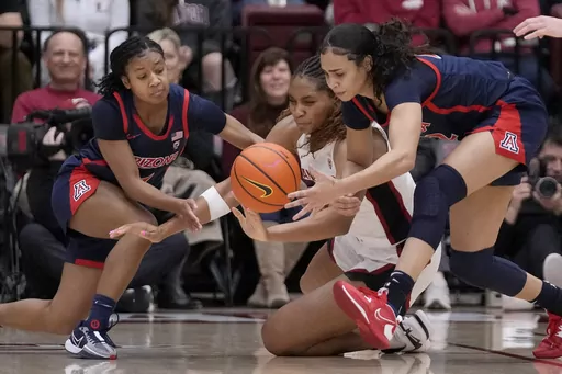 Arizona forward Esmery Martinez, right, grabs the ball in front of Arizona guard Courtney Blakely, left, and Stanford forward Kiki Iriafen, center, during the first half of an NCAA college basketball game in Stanford, Calif., Friday, Feb. 23, 2024. (AP Photo/Jeff Chiu)