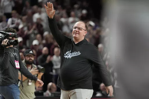 Texas A&M head football coach Mike Elko waves to the crowd at Reed arena during an NCAA college basketball game between Texas A&M and Kentucky on Saturday, Jan. 13, 2024, in College Station, Texas. The first full week for the upcoming college football season will feature a Saturday tripleheader on ABC, including Texas A&M hosting Notre Dame. ESPN announced its major matchups for Week 0 and Week 1 on Tuesday as part of its presentation to advertisers in New York. The Aug. 31 matchup marks Mike El