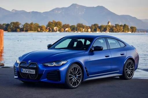 This photo provided by BMW shows the 2022 BMW i4, a new all-electric sedan with a rear cargo hatch and an estimated range of up to 301 miles. (Fabian Kirchbauer/BMW of North America via AP)