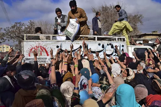 People jostle each other to buy subsidized sacks of wheat flour in Quetta, Pakistan, Thursday, Jan. 12, 2023, after a recent price hike of flour in the country. An Associated Press analysis of a dozen countries most indebted to China - including Pakistan, Kenya, Zambia and Laos - found the debt is consuming an ever-greater amount of tax revenue needed to keep schools open, provide electricity and pay for food and fuel. (AP Photo/Arshad Butt, File)